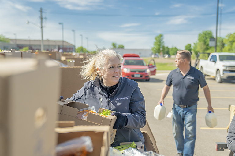 Sourcewell employees volunteering at food collection and distribution event