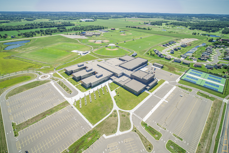 Aerial view of school building, parking lots, and tennis courts
